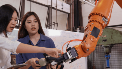 Two PHD students test robotics equipment